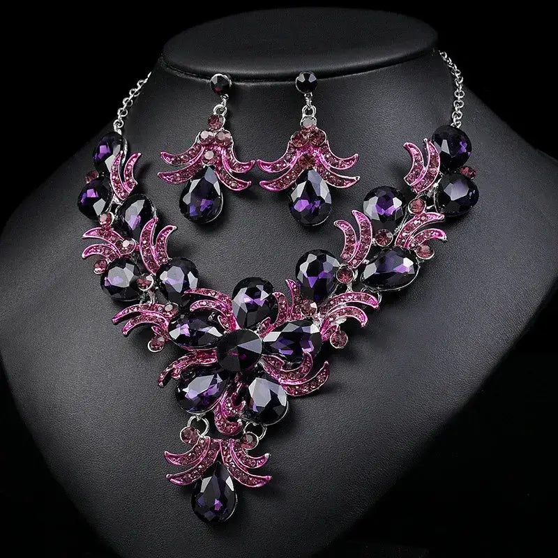 Stunning purple and pink jeweled necklace with matching earrings, perfect for elegant occasions or special events.
