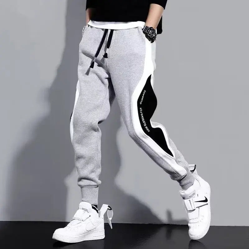 Men's gray jogger sweatpants with black side design, perfect for casual sportswear and daily wear.