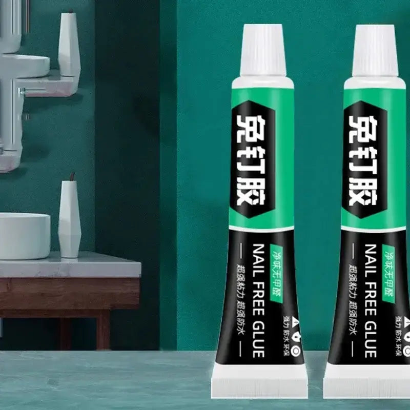 Two tubes of nail-free glue on a stylish kitchen countertop with modern decor.