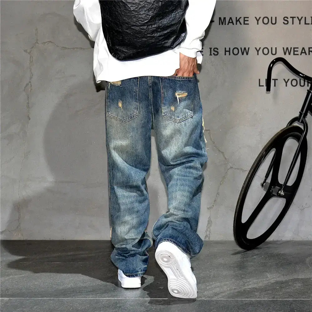 Casual denim pant trousers in a relaxed fit, perfect for stylish streetwear. Back view showcasing faded wash and loose silhouette.